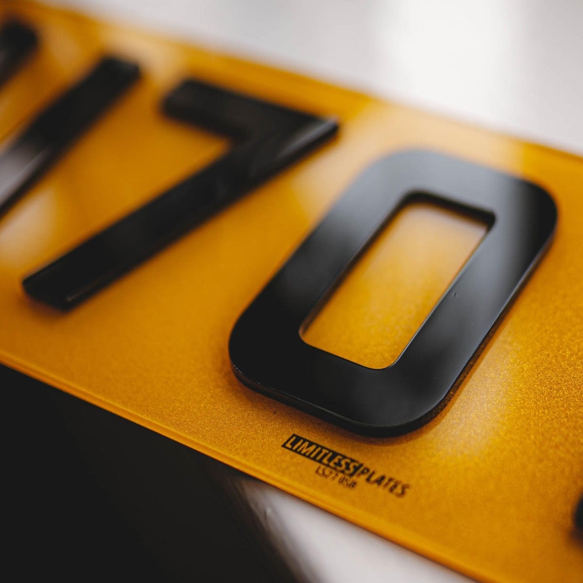 Close up of a laser-cut 4D acrylic digit bonded to a yellow rear plate